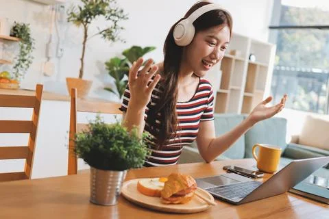 Asian woman using computer remote for business studying, watching online vi.. Stock-Fotos