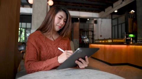 Asian woman using digital tablet at home office and cafe. Stock Footage 202064141
