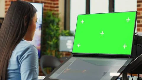 Asian woman using game developing software and greenscreen display Foto stock