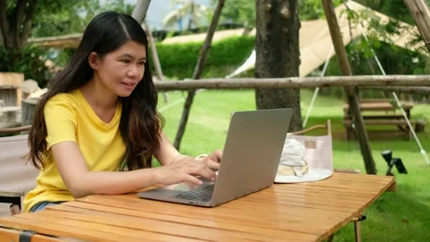 Asian woman using labtop to work in the garden at home. Stock Footage 206078123