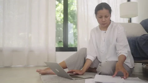 Asian woman using a laptop computer, typing work at home Stock Footage 200664705