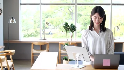 Asian Woman Using Self Check-In Kiosk at Modern Hotel Stock-Footage 344092287