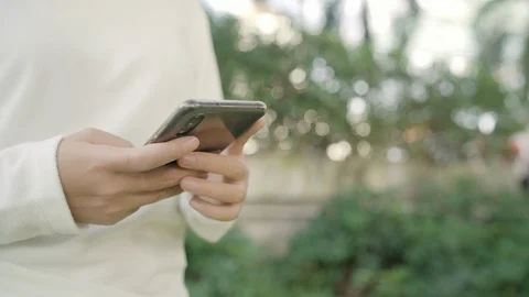 Asian woman using smartphone while walking on the street at downtown city. Stock Footage 102521315