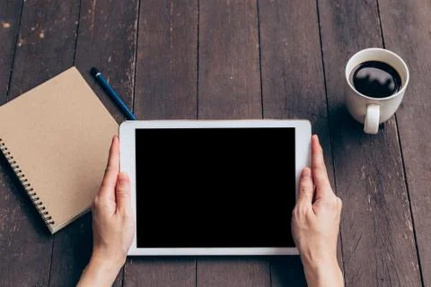 Asian woman using tablet on table in coffee shop with vintage toned. Stock Photos