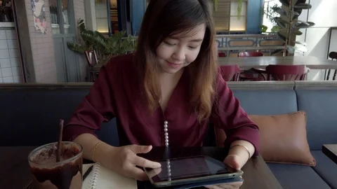 Asian woman using touchscreen tablet Video stock 104145813