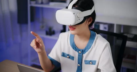 Asian woman using a virtual reality headset having fun exploring a 3D virtual  Stockbeeldmateriaal 293664518