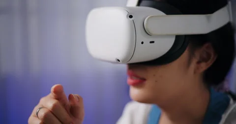 Asian woman using a virtual reality headset having fun exploring a 3D virtual  Stock-Footage 293668356