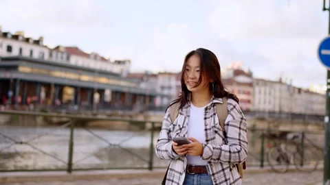 Asian woman walking while using phone. Stock Footage 287433629
