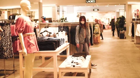 Asian woman wear white mask walking inside the store (mall) in new normal era. Stock Footage