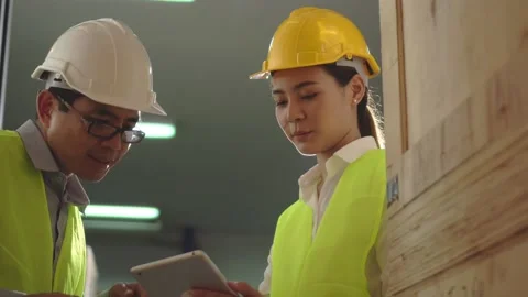 Asian woman worker use tablet and man engineer stand to talking check product 動画素材 152921189