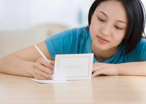Asian woman writing Thank You card Stock Photos