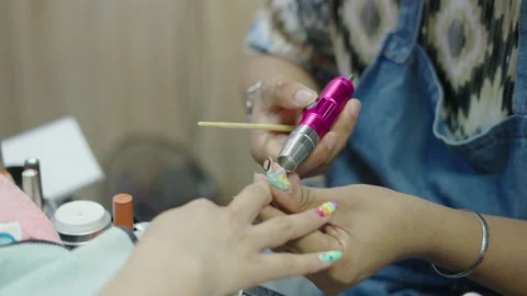 Asian womans hands doing a design on nails for a customer in Bangkok Stock-Footage 221518906