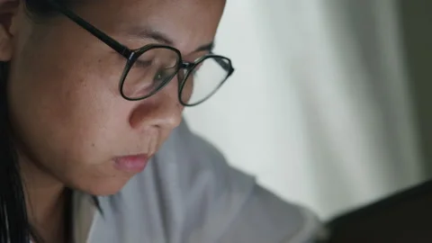 Asian women are using tablet domestic life at night. Stock Footage 131908370