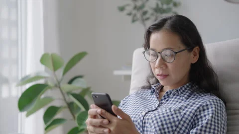 Asian women checking e-mali or message with smartphone Stock Footage 245431434