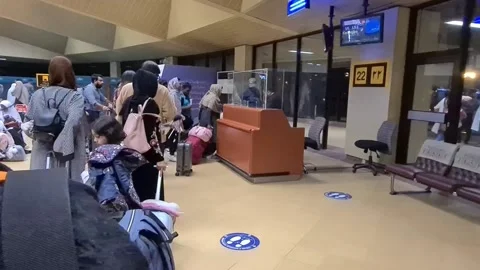 Asian women with hijab standing in a queue at airport Stock Footage 239757563