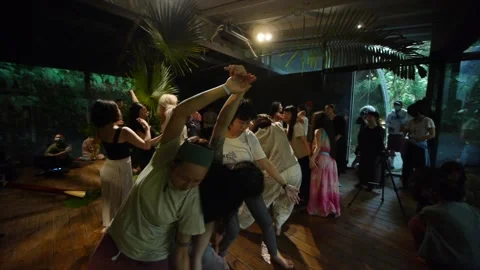 Asian women performing ecstatic improvisational dance at live jam with Stock Footage 193582138
