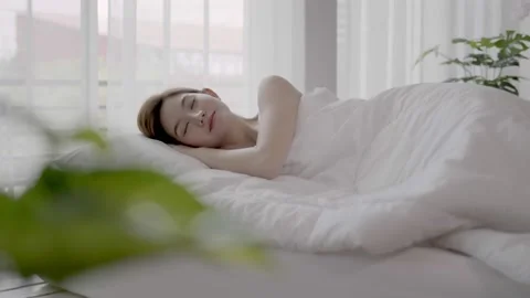 Asian women sleeping and sweet dream on white bed in bedroom Stock Footage