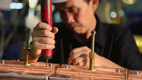 Asian worker attaching connector to copper box Stock Footage 139071889