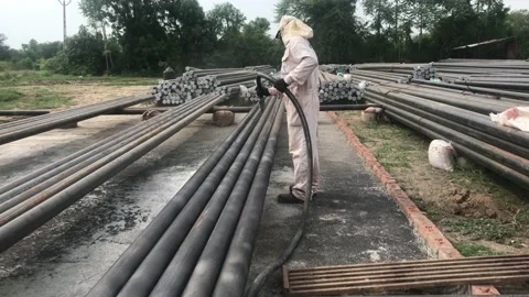 An Asian Worker Doing Sand Blasting of Mild Steel Pipe. Stock Footage 157283521