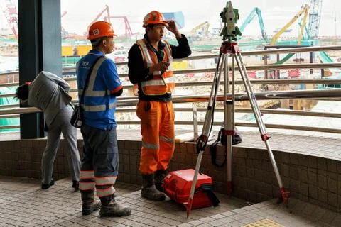 Asian workers in helmets do engineering work Hong Kong Stock Photos