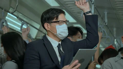 Asian working man wear face mask to prevent COVID-19 while traveling Stock Footage 158657702