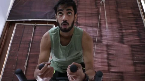 Asian Young beard man Doing cycling Cardio at home Stock Footage 144261890