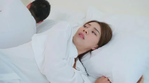 Asian young couple lying down on bed with painful after fight argument. Stock Footage 171271999