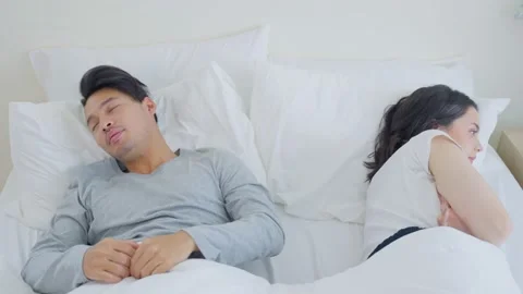 Asian young couple lying down on bed with painful after fight argument. Stock Footage 171274572