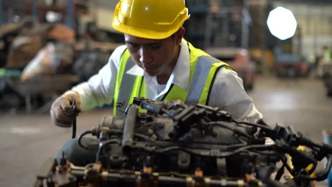 Asian young engineer checking list old used car engine in machinery parts sho Video stock 153568724