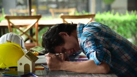 Asian young engineer man stress and failure in architecture project sitting at o Stockbeeldmateriaal 248416570