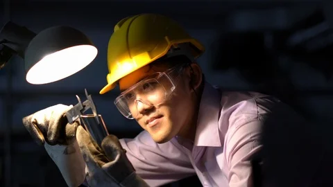 Asian young engineer working and using tools measurement quality of metal parts. Stock Footage 93603839