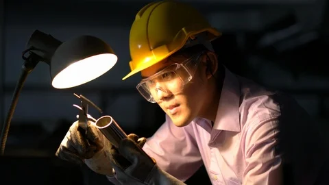 Asian young engineer working and using tools measurement quality of metal parts. Stock Footage 93603937