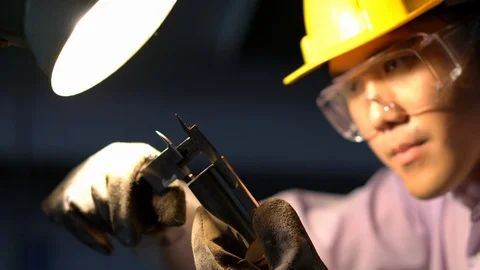 Asian young engineer working and using tools measurement quality of metal parts. Stock Footage 93604105
