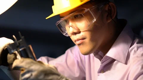 Asian young engineer working and using tools measurement quality of metal parts. Stock Footage 93604401