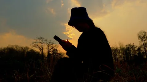 Asian young female farmer using smartphone on her agricultural field in Thailand Stock Footage 125624896