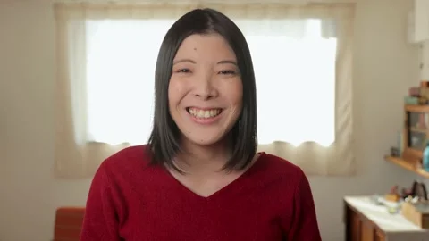 Asian young female smiles for the camera. Living room of apartment. 25P. Stock Footage 224908928