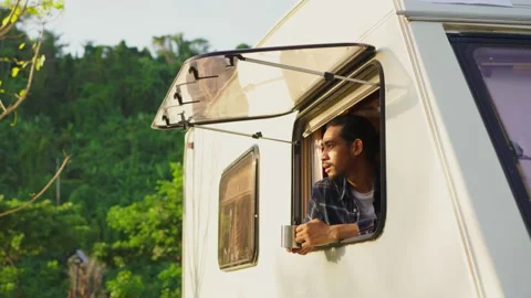 Asian young man feeling relax on camper van drinking coffee and smile in morning Stock Footage 164938599