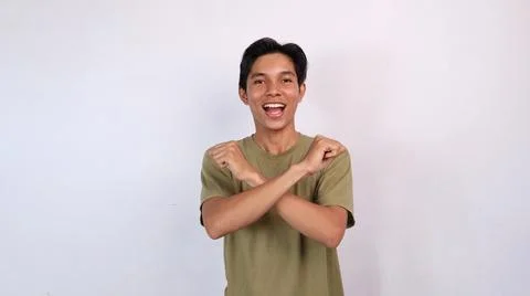 Asian young man gesturing with both hands crossed, rejection Stock-Fotos