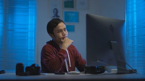  Asian young man getting tired and sleepy when working from home at night Stock Footage 129451603