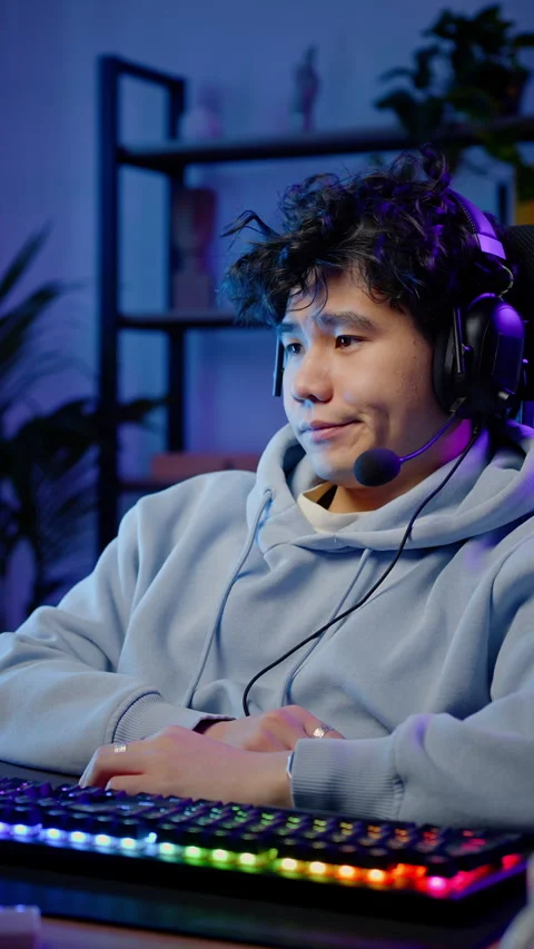 Asian young man streamer, computer games addicted in headphones, playing online Stock Footage 319477751