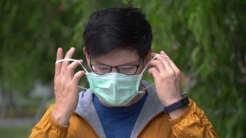 Asian young man take off protective face mask End of Coronavirus or Covid-19 Stock Footage 146653270