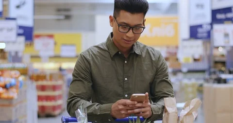 Asian young man tapping and typing while texting and chatting on the smartphone Stock-Footage 117633581