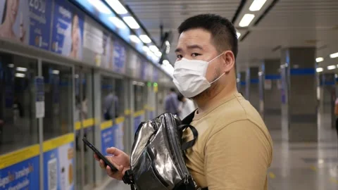 Asian young man use 5g smartphone mobile phone in the subway station while .. Stock-Footage 249679751