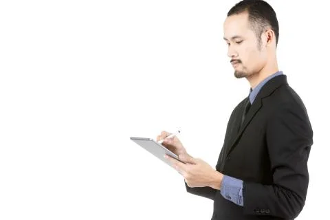Asian Young Man Using Digital Tablet Isolated On White . Stock Photos