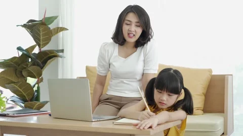 Asian young mother with computer teaching kid to learn online Stock Footage 168170087