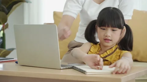 Asian young mother with computer teaching kid to learn online Stock Footage 168170115