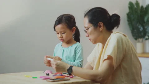 Asian young mother teach daughter to do homework and playing together Stock Footage