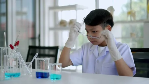 Asian young scientist gets bored while studying chemistry in laboratory Stock Footage 201361382
