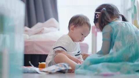 Asian young siblings playing with each other inside home cozy living room. Stock Footage 279505861
