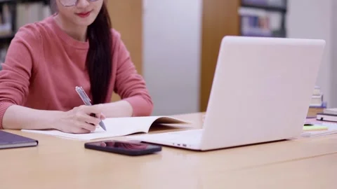 Asian young women student using laptop computer writing notes studying read.. Stock Footage 335003363